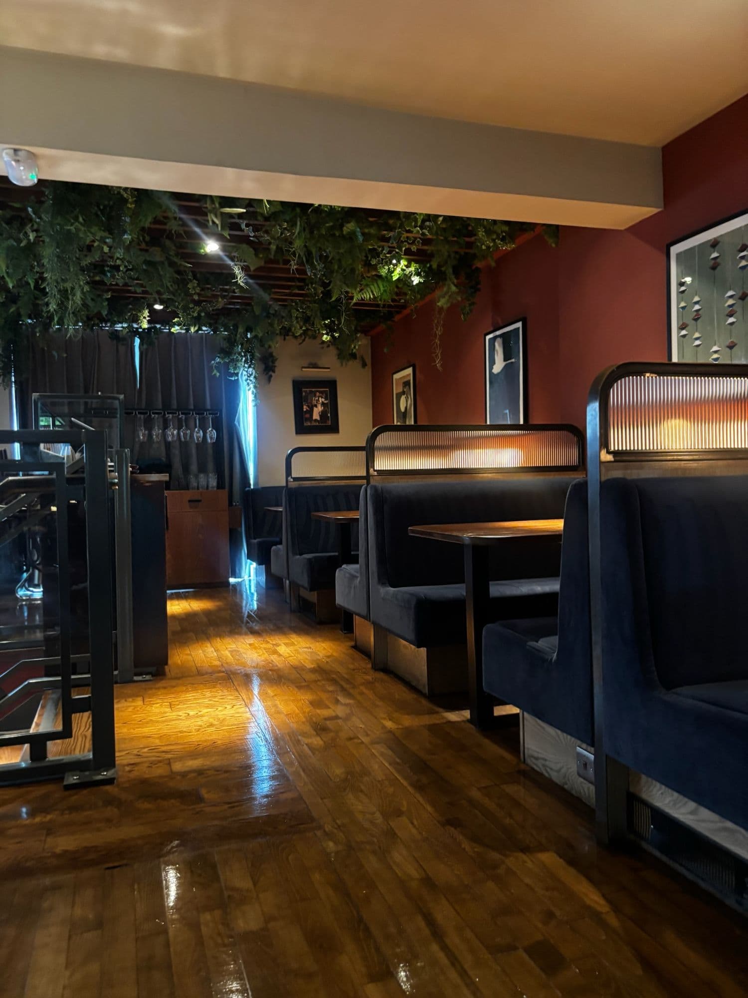 Restaurant booths with navy seating along a polished timber floor