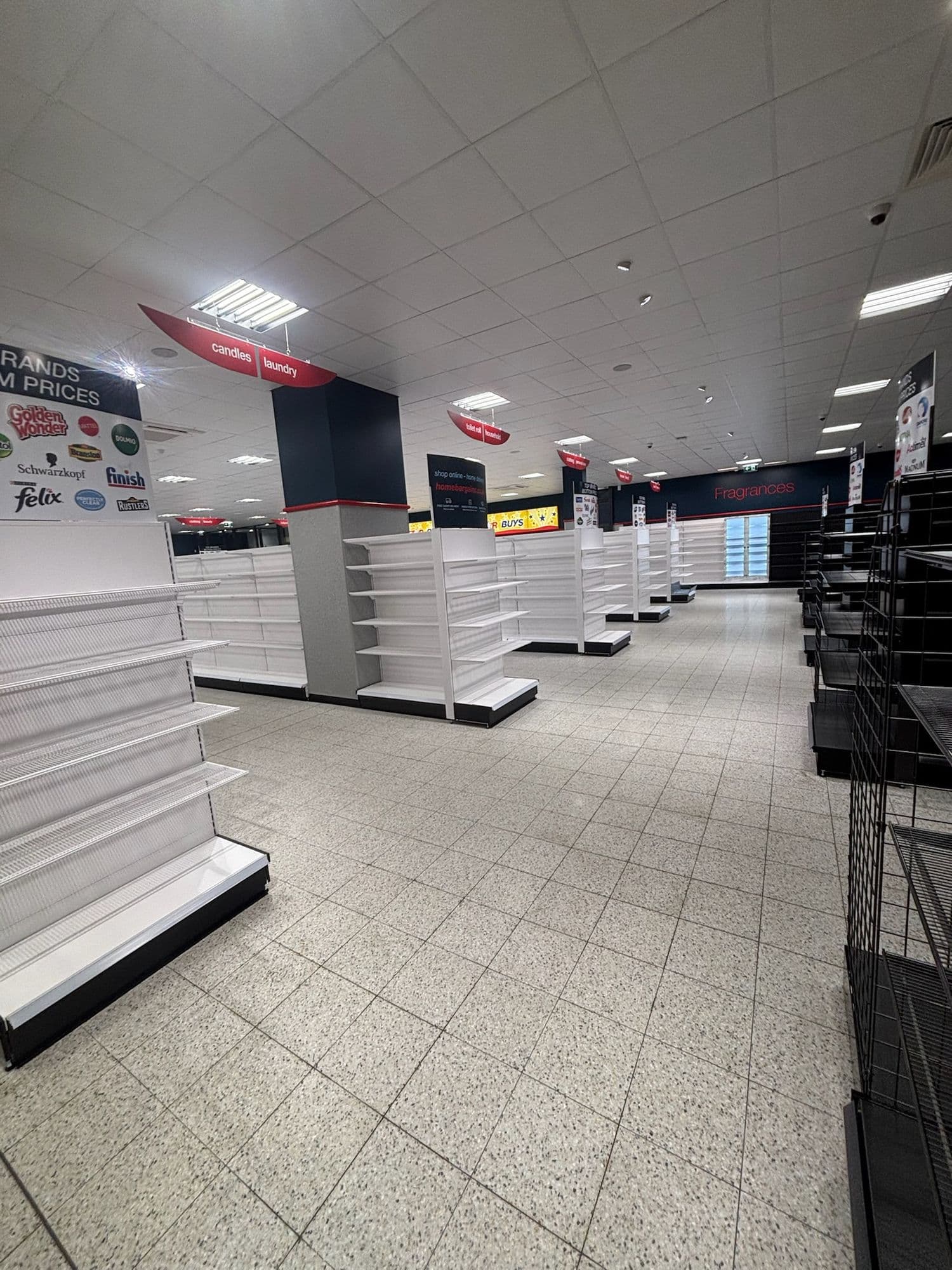 New store with white and black shelving bays ready to be stocked