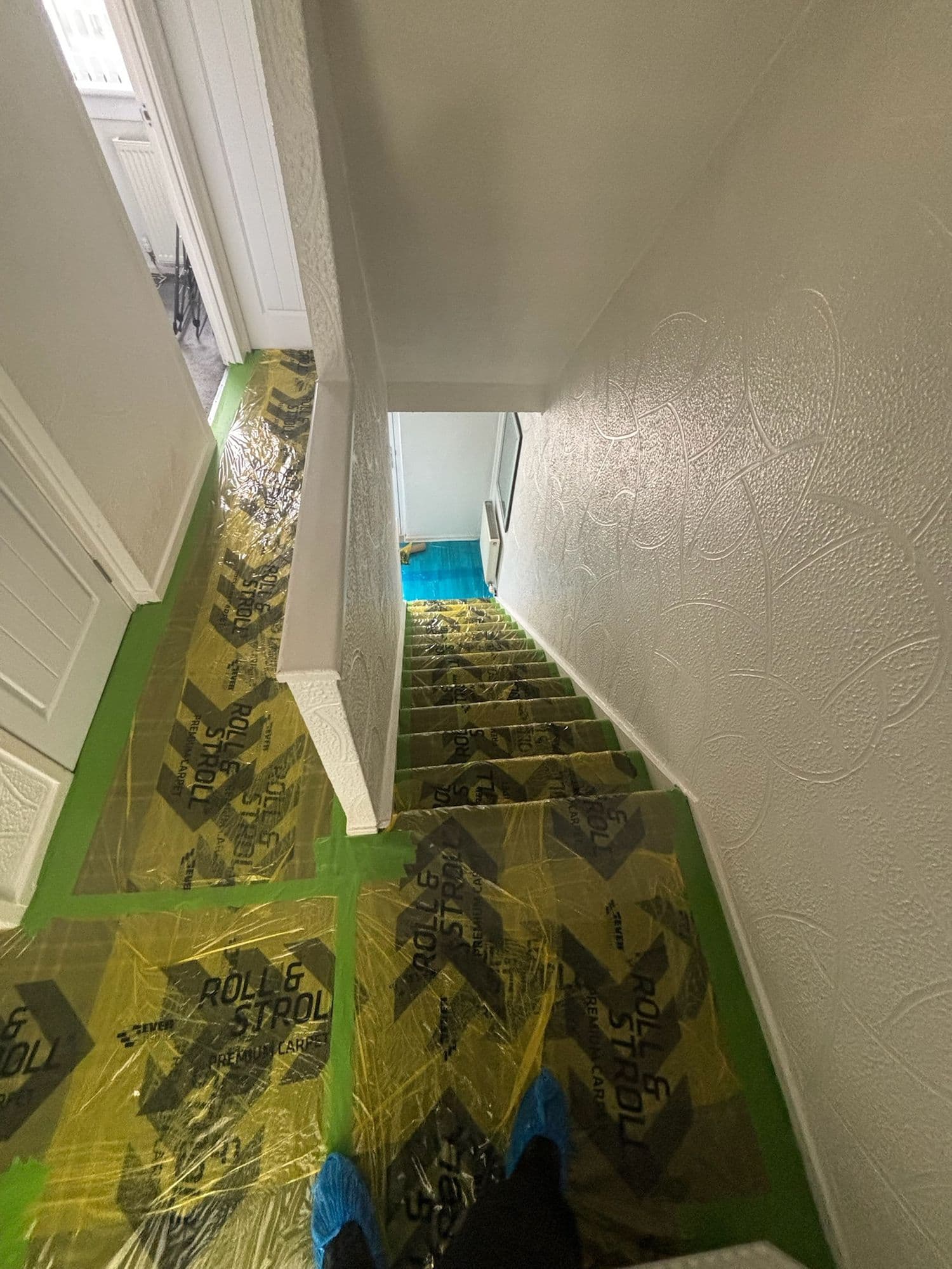 Staircase and landing protected with film and board during works